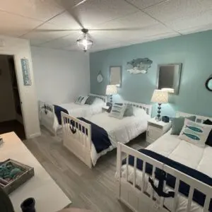 White aqua theme bedroom with three beds
