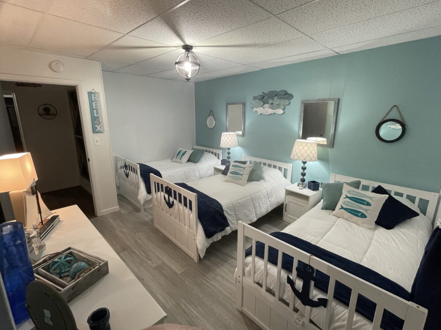 White aqua theme bedroom with three beds